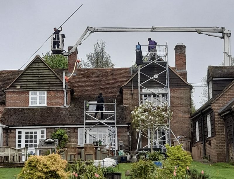 The Roof Moss Cleaners using cherry picker and scaffolding to clean roof safely and professionally in Potton, Bedfordshire