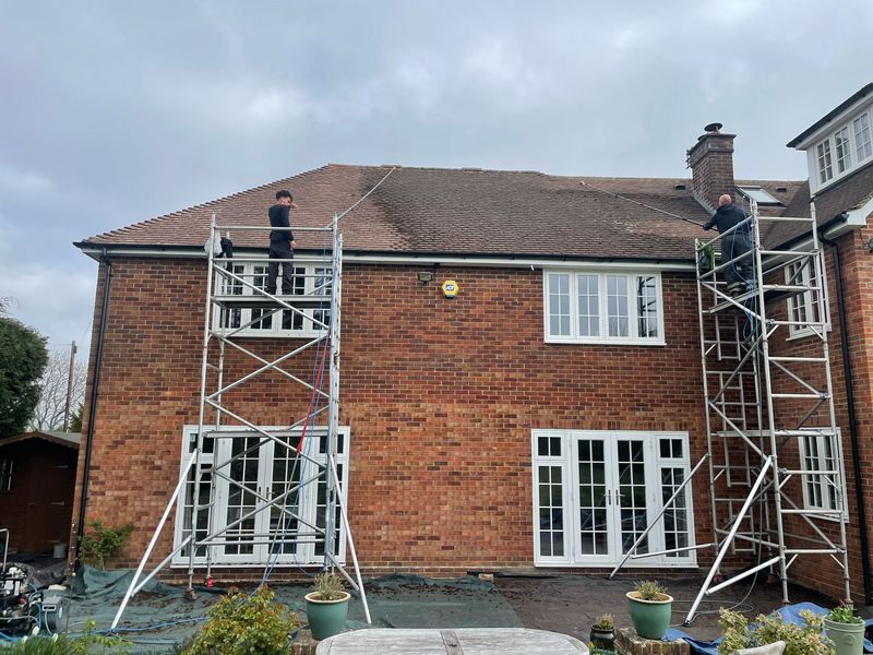 Roof cleaning carried out safely from scaffold towers by The Roof Moss Cleaners in Potton